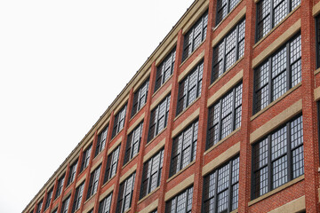Brick buildings: icons of stability, progress, and community. Offices and apartment complexes symbolize growth, urban living, and shared aspirations