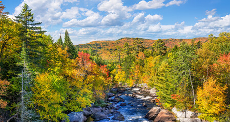Fototapeta na wymiar Autumn colors on the Magalloway River in western Maine - scenic drive on Highway 16