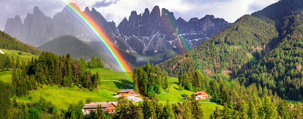 Majestic Dolomites rocks - most beautiful mountains in Alps, UNESCO site. Unique shoot with rainbow. Beautiful valley Val di Funes in South Tyrol, Italy - obrazy, fototapety, plakaty