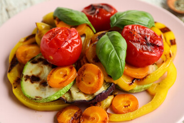 Plate with grilled vegetables and basil, closeup