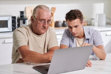 Young man and his grandfather discussing what to order for dinner