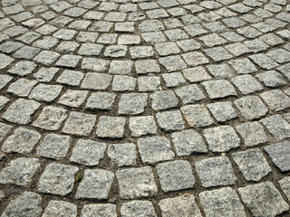 Fragment of a pavement made of roughly processed stones