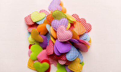 many different multi-colored, bright fabric hearts