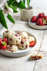 Homemade cookies with strawberries. Delicious summer pastries on pink tile background