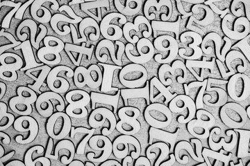 Abstract background with numbers cut out of plywood.