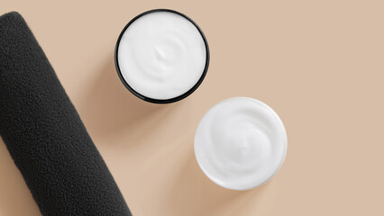 White cream in jars and a towel. On a beige background