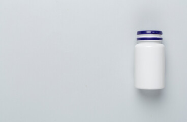 Plastic bottle with vitamins on color background, top view