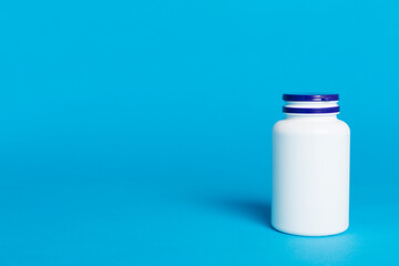 Plastic bottle for vitamins on color background