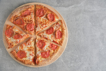 Pepperoni pizza with sausage gray concrete background.