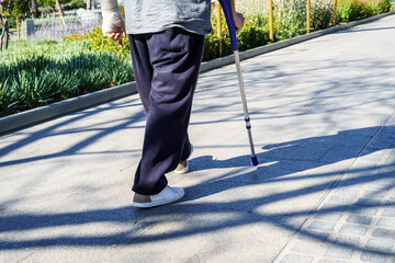 Adult person with a crutch due to a leg injury. Process of recovery from an accident