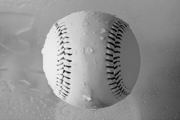 Rain game concept for baseball with water on ball in black and white closeup.