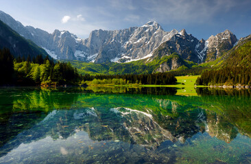 Fototapeta premium Picturesque mountain scenery and hiking place. Beautiful superior Fusine lake and Mangart mountain in background, Julian Alps, Tarvisio, Udine region, Friuli Venezia Giulia, Italy, Europe 