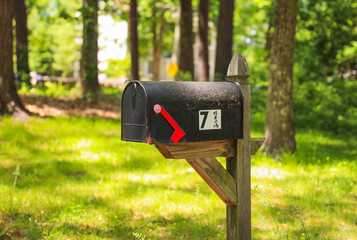 A quaint mailbox stands in front of a charming house, symbolizing communication, connection, and a...