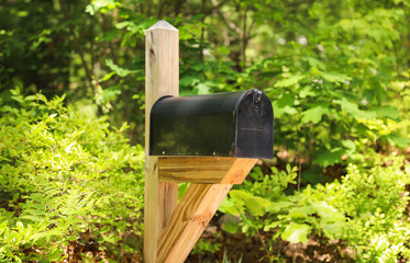 A quaint mailbox stands in front of a charming house, symbolizing communication, connection, and a sense of home