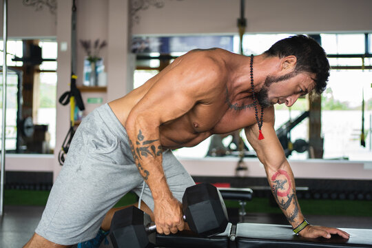 Strong Man Doing Tricep Exercises With Dumbbell