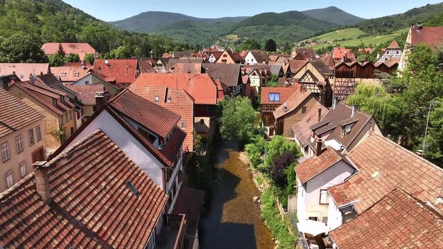 Aerial Drone Shot of the river in village of Kaysersberg in Alsace in a day. Summer in France, Cute French Village