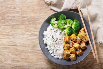 plate of rice, fried tofu, broccoli with sesame seeds, top view