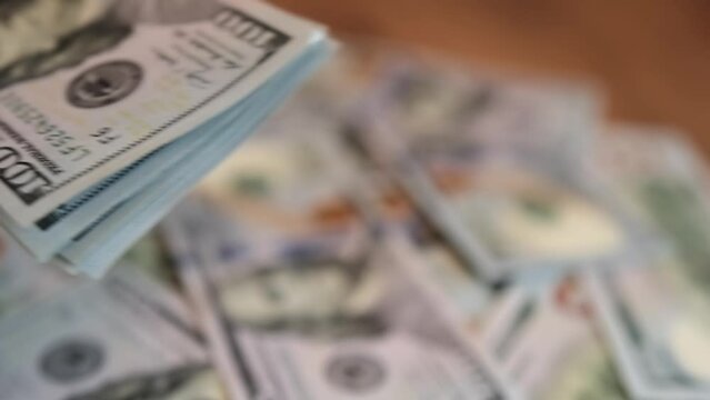 Close up male hand spending the money lot of us dollar to customer for the cost. Financial business concept. Bribery and extortion of money.