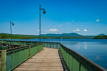 walkway along the shore of Lake Memphremagog in Newport , Vermont looking across at Quebec Canada
