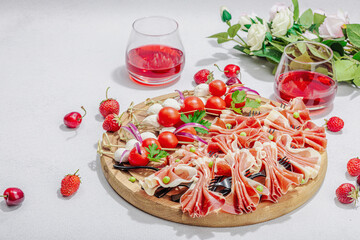 Picnic food concept. Basket with wine and baguette, set of snacks on skewers. Meat, cheese