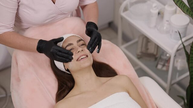 Face mask, Soothing mask, Skincare treatment. In professional skincare treatment, soothing cream is gently worked into face, and mask is applied afterward.