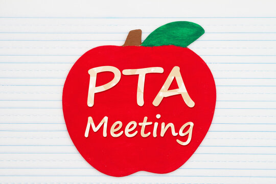 PTA meeting message on a wooden apple on vintage ruled line notebook paper