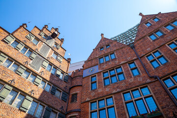 Fototapeta na wymiar Look up through Bremen old town red brick building in Böttcherstraße, Bremen