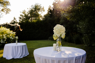 Backyard wedding tables and decor set up during summer.