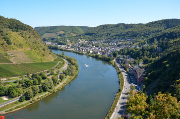 View from the Reichsburg Cochem in the Hunsrück to the river Mosel and the vineyards and a small town at the edge of the forest