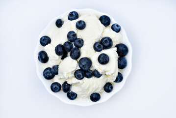 Ice cream with berries. Ice cream in a ceramic bowl. Ice cream and blueberries.