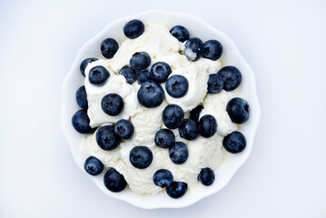 Ice cream with berries. Ice cream in a ceramic bowl. Ice cream and blueberries.