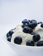 Ice cream with berries. Ice cream in a ceramic bowl. Ice cream and blueberries.