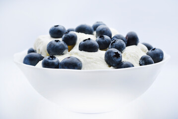 Ice cream with berries. Ice cream in a ceramic bowl. Ice cream and blueberries.