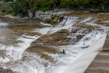 Naklejka premium McGowan Falls in the small town of Durham, Ontario pours over the rocks in the Saugeen River.