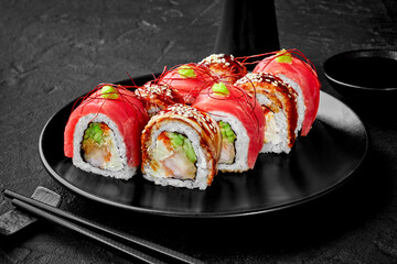 Sushi rolls with shrimp, cucumber, eel and tuna served with soy sauce