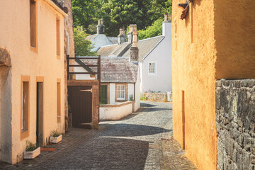 Charming and quaint old town cobblestone lane and harling cottages in the medieval village of Culross, a popular filming location in Fife, Scotland, UK.