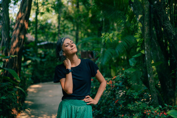 girl stands on the background of tropical trees