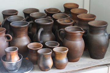 earthenware pots and earthenware jugs on a shelf in pottery