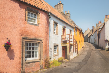 Fototapeta na wymiar Charming and quaint old town lane and colourful harling cottages in the medieval village of Culross, a popular filming location in Fife, Scotland, UK.