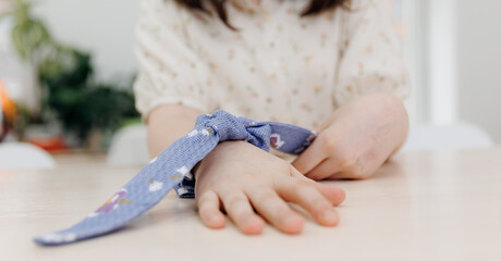 Happy Little girl learns to sew, seamstress master class in school