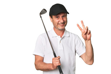 Middle aged golfer man joyful and carefree showing a peace symbol with fingers.