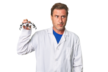 A middle-aged optometrist man confused, feels doubtful and unsure.