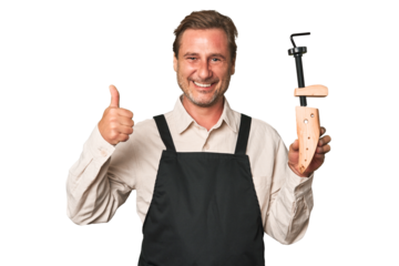A middle-aged shoe maker smiling and raising thumb up