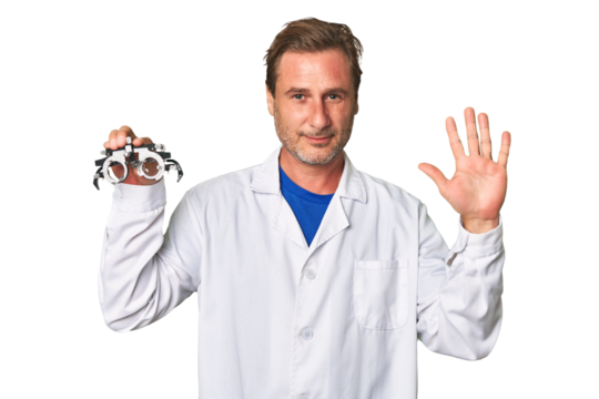 A middle-aged optometrist man smiling cheerful showing number five with fingers.
