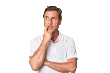 A middle-aged man isolated looking sideways with doubtful and skeptical expression.