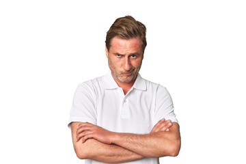 A middle-aged man isolated frowning face in displeasure, keeps arms folded.