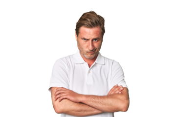 A middle-aged man isolated frowning face in displeasure, keeps arms folded.
