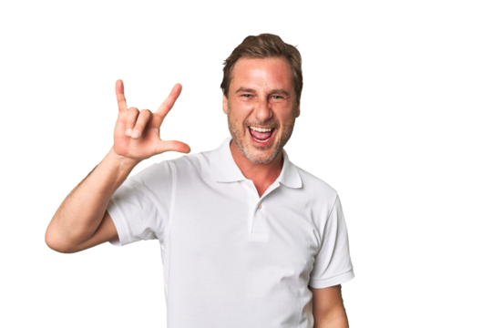 A middle-aged man isolated showing a horns gesture as a revolution concept. - Powered by Adobe