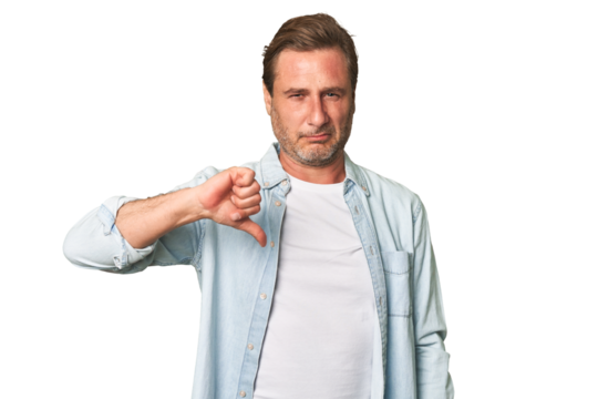 A middle-aged man isolated showing thumb down, disappointment concept.