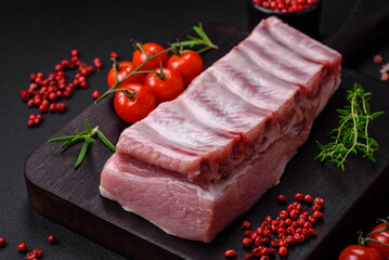 Raw pork ribs with meat with salt, spices and herbs